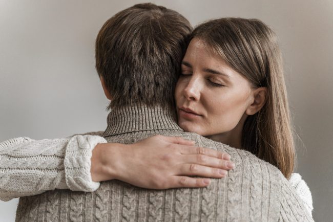 adult-woman-hugging-her-husband